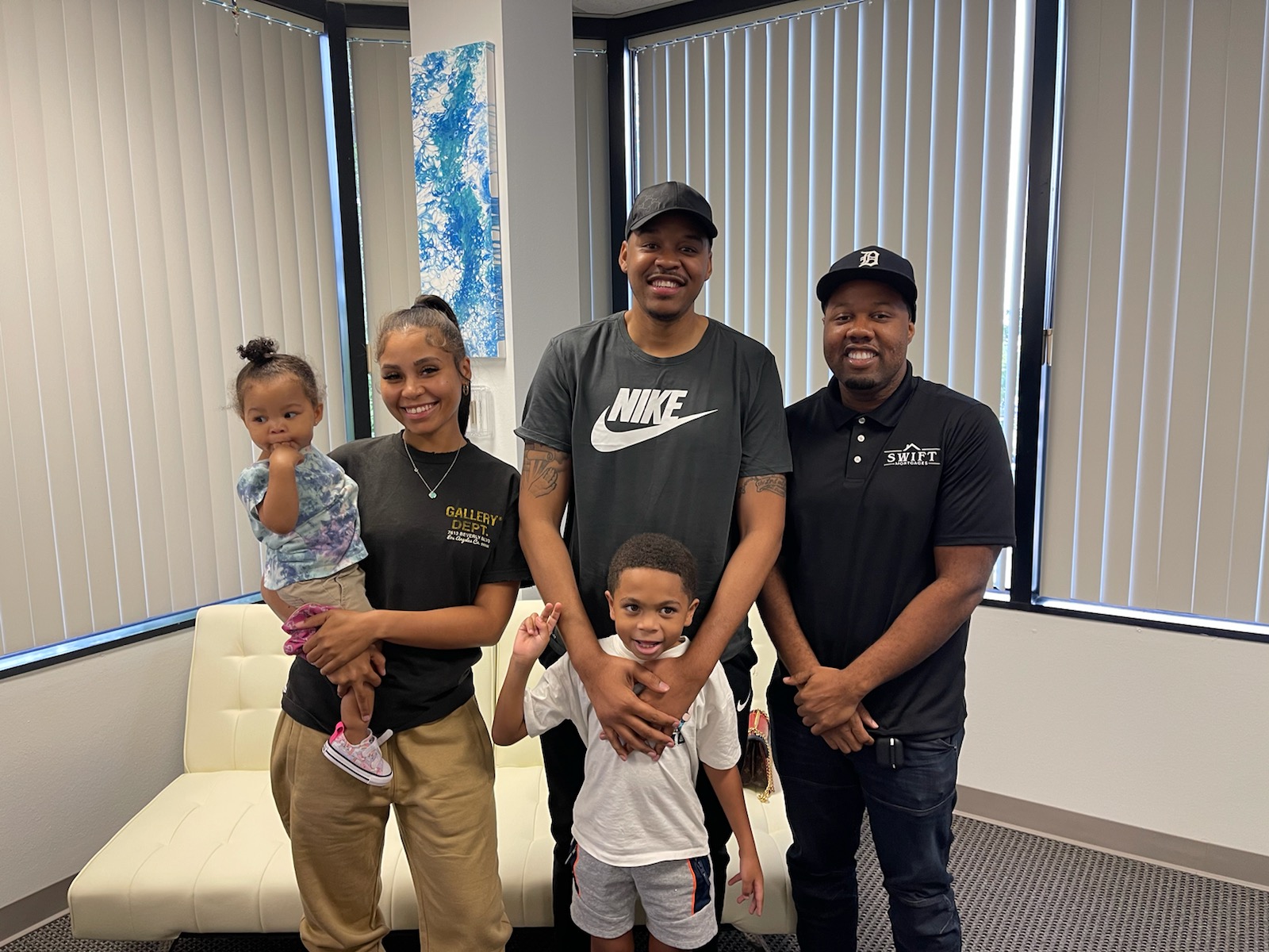 Marlon Wilson posing with a family after a successful closing.